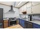 A close view of the kitchen including stainless steel oven, dishwasher, sink, granite counters, and white subway tile at 6719 Sunset Valley Cir, Rex, GA 30273