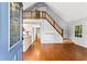 Open living space with hardwood floors, staircase, and a view of the kitchen at 6719 Sunset Valley Cir, Rex, GA 30273