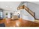 Open concept layout showcasing hardwood floors, staircase, kitchen, and plenty of light at 6719 Sunset Valley Cir, Rex, GA 30273
