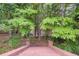 A descending brick staircase with ornate brick and lantern post, with lush green trees in the background at 1350 Whitley Rd, Dacula, GA 30019