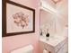 Bathroom featuring a vanity, mirror, lighting, and tasteful floral artwork at 1350 Whitley Rd, Dacula, GA 30019