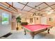 Billiards room features a classic red pool table and access to the backyard through a door at 1350 Whitley Rd, Dacula, GA 30019