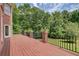 Wide wood deck overlooking the backyard surrounded by lush trees and iron railings at 1350 Whitley Rd, Dacula, GA 30019