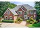 An eye-level view of the house that highlights lush trees and shrubbery around the exterior at 1350 Whitley Rd, Dacula, GA 30019