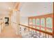 Upstairs hallway with views of the living room, tall windows, and natural light at 1350 Whitley Rd, Dacula, GA 30019