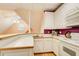 Partial kitchen featuring white cabinets and bar top at 1350 Whitley Rd, Dacula, GA 30019