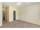 Large bedroom with neutral carpeting, ceiling fan, and walk in closet at 2284 Nicole Dr, Hampton, GA 30228
