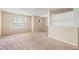 Spacious finished basement with neutral carpeting and built-in shelving at 2284 Nicole Dr, Hampton, GA 30228