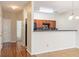 Open kitchen area with wooden cabinets and a breakfast bar, adjacent to a staircase at 2284 Nicole Dr, Hampton, GA 30228