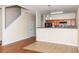 Open kitchen area with wooden cabinets and a breakfast bar, adjacent to a staircase at 2284 Nicole Dr, Hampton, GA 30228