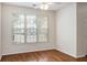 Bright living room featuring a large window with wood floors and light colored walls at 2284 Nicole Dr, Hampton, GA 30228