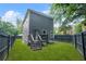 Two-story home with a fenced backyard featuring a small deck area at 935 Pelham Nw St, Atlanta, GA 30318