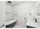 Modern bathroom with marble tile, a soaking tub, and sleek fixtures at 935 Pelham Nw St, Atlanta, GA 30318