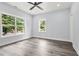 Spacious bedroom with views of tree-lined street, gray vinyl flooring, and neutral paint at 935 Pelham Nw St, Atlanta, GA 30318