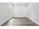 Bedroom featuring gray vinyl flooring, one window, neutral paint, and a closet at 935 Pelham Nw St, Atlanta, GA 30318