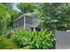 Gray two-story house featuring a well-kept lawn and a dark fenced perimeter at 935 Pelham Nw St, Atlanta, GA 30318