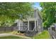 Charming gray two-story home with a cozy front porch and well-maintained landscaping at 935 Pelham Nw St, Atlanta, GA 30318