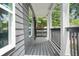 View of the front porch with classic railings and white columns at 935 Pelham Nw St, Atlanta, GA 30318