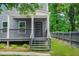 Inviting gray home with a charming front porch and steps leading to the entrance at 935 Pelham Nw St, Atlanta, GA 30318