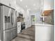 Kitchen with stainless steel appliances, white cabinets and hardwood flooring at 935 Pelham Nw St, Atlanta, GA 30318