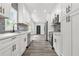 Well-lit kitchen with stainless appliances, white cabinets, and modern fixtures at 935 Pelham Nw St, Atlanta, GA 30318