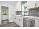 Modern kitchen featuring stainless steel appliances, white cabinets, and ample counter space at 935 Pelham Nw St, Atlanta, GA 30318