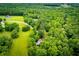 Aerial view of a home on a spacious lot surrounded by lush greenery at 1775 Whooping Creek Rd, Carrollton, GA 30116