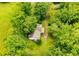Aerial view of a home surrounded by lush greenery and mature trees at 1775 Whooping Creek Rd, Carrollton, GA 30116