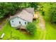 Aerial view of a house with a large lot surrounded by lush trees and a deck at 1775 Whooping Creek Rd, Carrollton, GA 30116