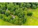Scenic aerial view of a home nestled amidst lush greenery and mature trees at 1775 Whooping Creek Rd, Carrollton, GA 30116