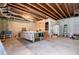 Unfinished basement with concrete floors and a vintage pool table at 1775 Whooping Creek Rd, Carrollton, GA 30116