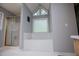 Bathroom featuring a large soaking tub, separate shower, and bright natural light for a spa-like experience at 1775 Whooping Creek Rd, Carrollton, GA 30116