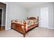 Bedroom with a wooden bed frame and neutral walls with two doors at 1775 Whooping Creek Rd, Carrollton, GA 30116