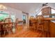 Open-concept dining area featuring a stone fireplace, wood floors, and natural light at 1775 Whooping Creek Rd, Carrollton, GA 30116