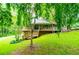 Lovely exterior view showcasing wooden decking and a green lawn at 1775 Whooping Creek Rd, Carrollton, GA 30116