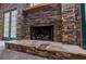 Close-up shot of stone fireplace, showcasing its craftsmanship and inviting hearth with log storage at 1775 Whooping Creek Rd, Carrollton, GA 30116