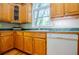 Functional kitchen area with wood cabinets and bright natural light at 1775 Whooping Creek Rd, Carrollton, GA 30116