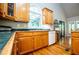 Classic kitchen with wooden cabinetry, updated appliances, and a bright window at 1775 Whooping Creek Rd, Carrollton, GA 30116