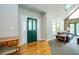 Welcoming foyer with stone fireplace, hardwood floors, and a green front door at 1775 Whooping Creek Rd, Carrollton, GA 30116