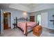 Bedroom with a plush bed, sliding glass doors, and soothing decor for ultimate relaxation at 1775 Whooping Creek Rd, Carrollton, GA 30116