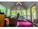 Bright sunroom with panoramic windows, comfortable seating, and natural light, perfect for relaxation at 1775 Whooping Creek Rd, Carrollton, GA 30116