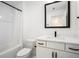 Clean bathroom featuring a bathtub and shower, plus a white vanity with a black framed mirror at 383 Pratt Se Dr # 503, Atlanta, GA 30315