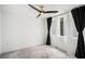 Bright bedroom with large windows covered by sheer white and blackout curtains, and a modern ceiling fan at 383 Pratt Se Dr # 503, Atlanta, GA 30315