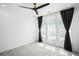 A minimalist bedroom featuring carpeted floors, natural light, and a modern ceiling fan at 383 Pratt Se Dr # 503, Atlanta, GA 30315