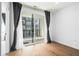 Sunlit bedroom featuring hardwood floors and a glass sliding door to a private balcony at 383 Pratt Se Dr # 503, Atlanta, GA 30315