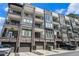Modern townhome exterior featuring brick accents, private balconies, and convenient garage parking at 383 Pratt Se Dr # 503, Atlanta, GA 30315