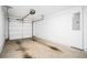 Spacious two-car garage with an automatic door opener, electrical panel, and stained concrete floor at 383 Pratt Se Dr # 503, Atlanta, GA 30315