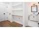 Hallway featuring hardwood floors, recessed lighting, and a built-in bookshelf, and a view to the bathroom at 383 Pratt Se Dr # 503, Atlanta, GA 30315