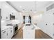 An open kitchen with a quartz countertop island, stainless steel appliances, and white cabinets at 383 Pratt Se Dr # 503, Atlanta, GA 30315