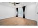 Spacious living room with light wood floors, ceiling fan, and natural light from sheer curtained windows at 383 Pratt Se Dr # 503, Atlanta, GA 30315